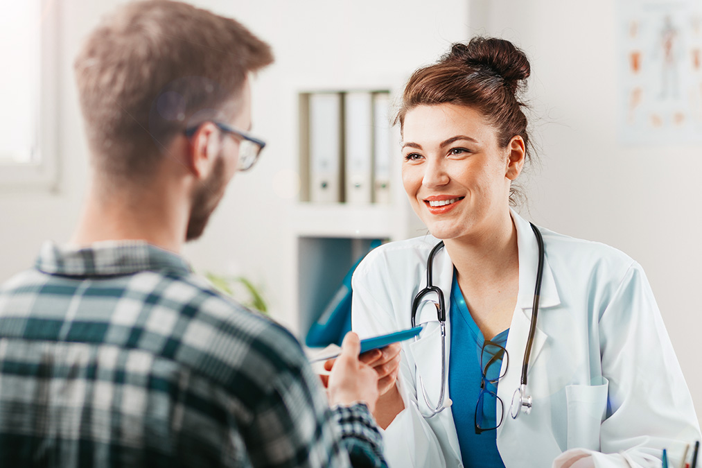 Primary Care provider speaking with patient in exam room