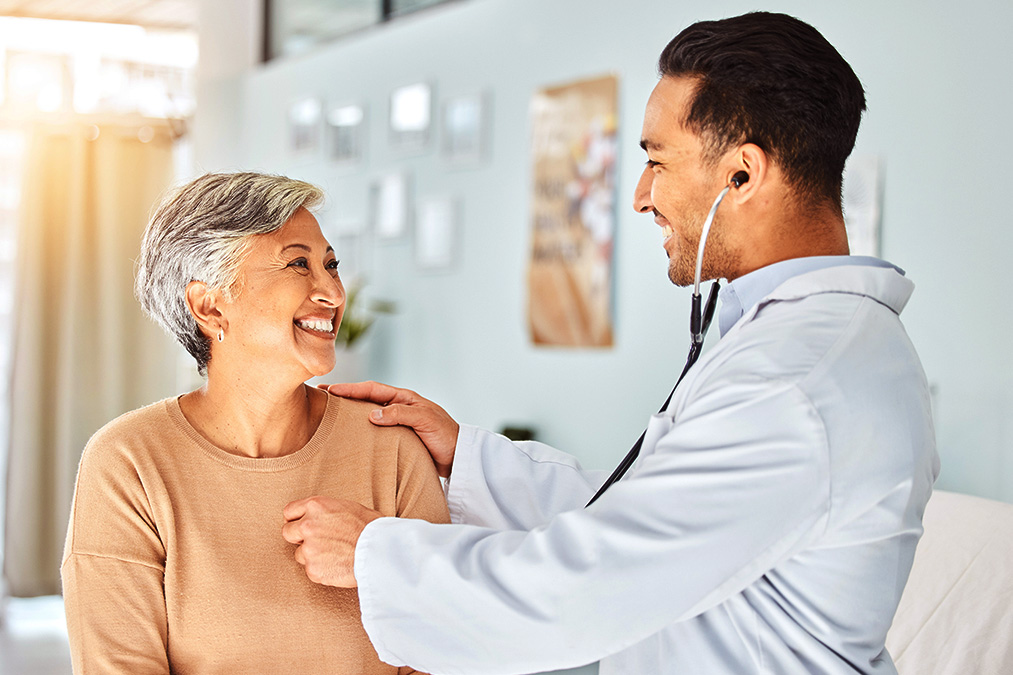 Doctor checking patient vitals at transitions of care clinic